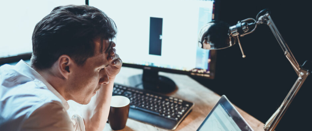 stressed man at a desk