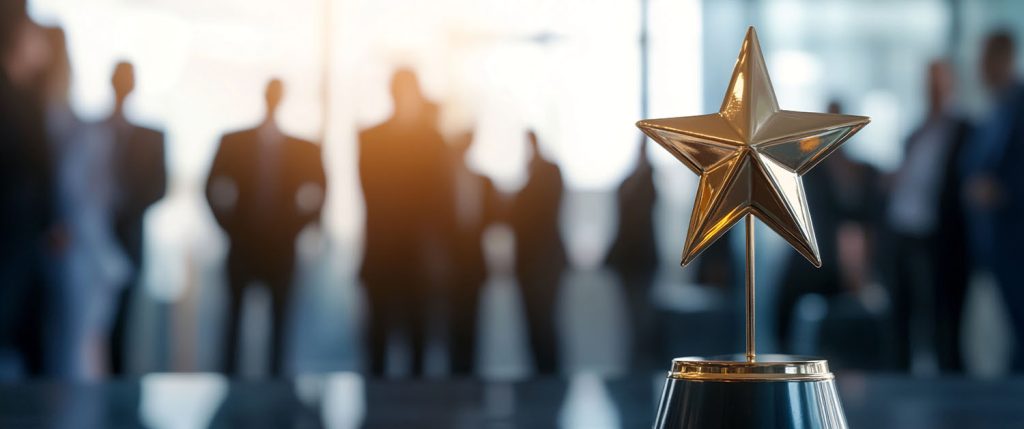 Gold star trophy on a pedestal with a blurred conference-room crowd in the background, symbolizing achievement in a corporate setting.